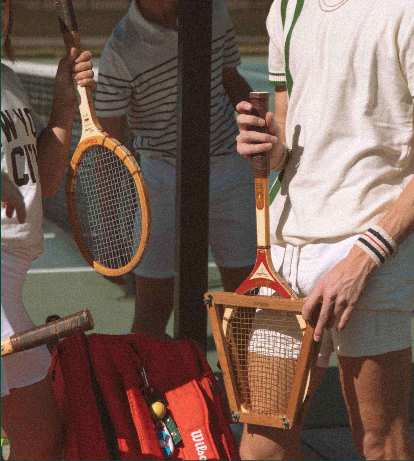 Vintage tennis players holding wooden rackets