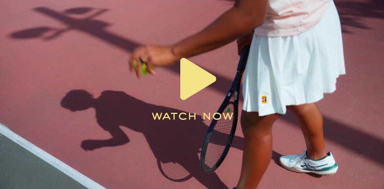 Watch now — young player walking on a pink tennis court