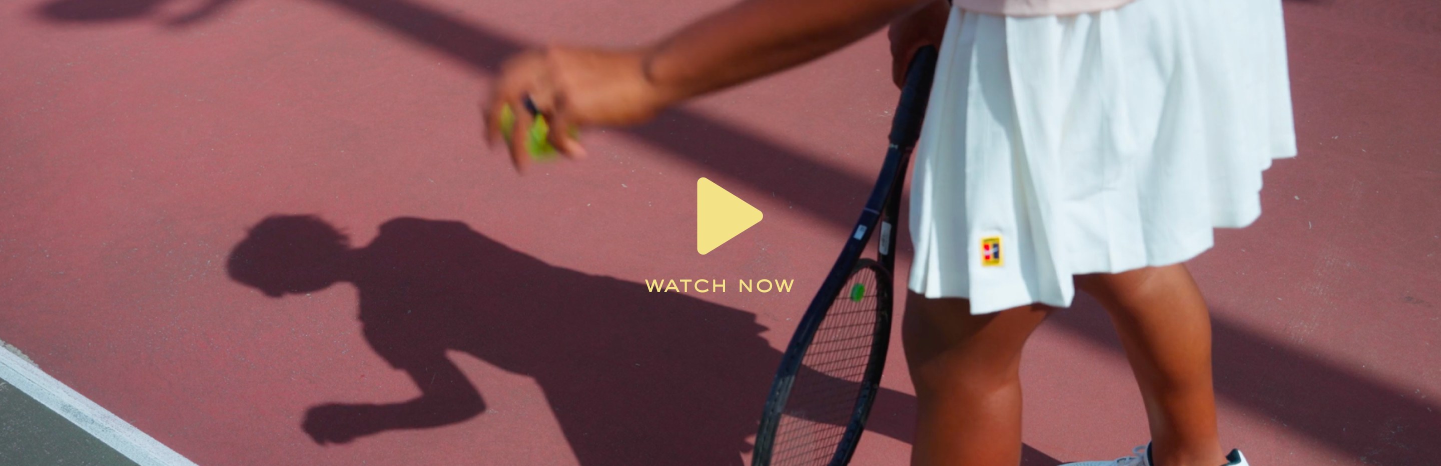 Watch now — young player walking on a pink tennis court