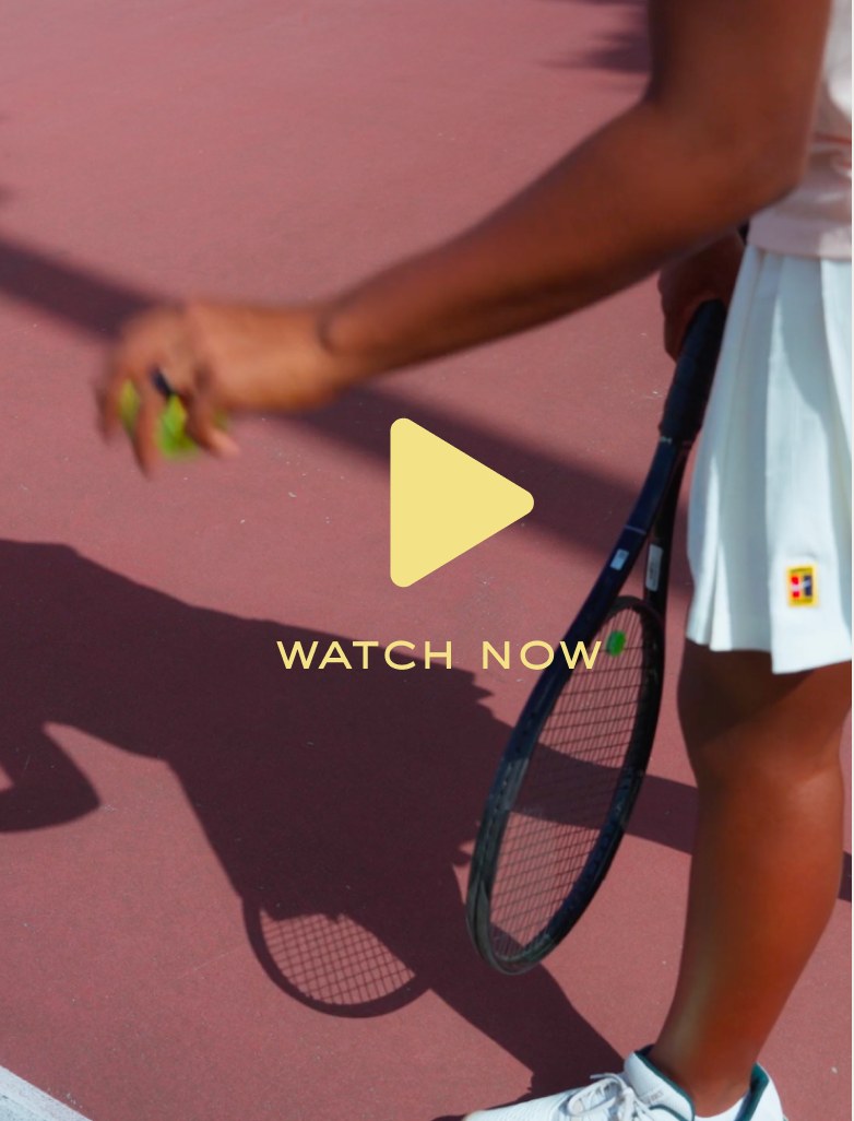 Watch now — young player walking on a pink tennis court