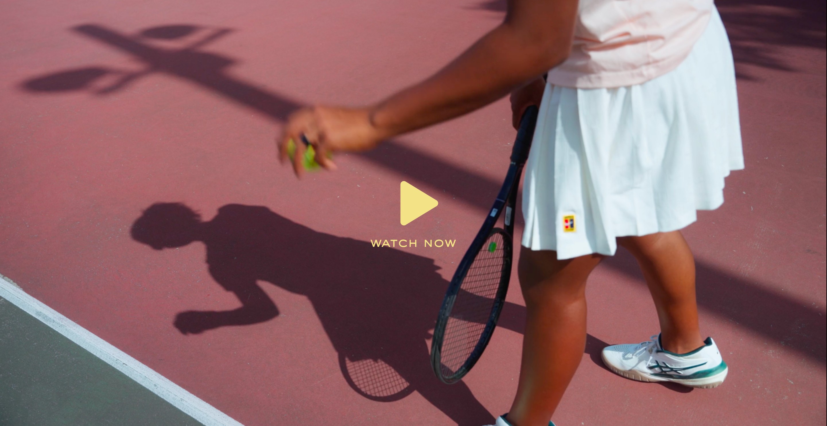 Watch now — young player walking on a pink tennis court